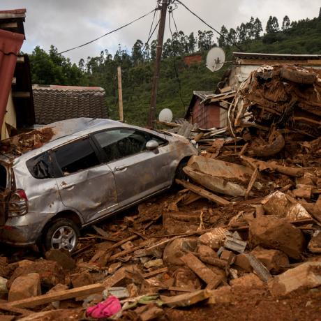 A car and house destroyed by rubble after Cyclone Idai