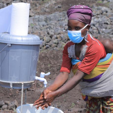 Mwavita uses a handwashing station